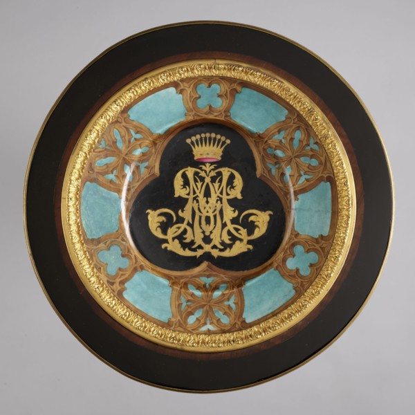 Round table, lacquered black, decorated with gilded cast brass fittings, with a ceramic painted