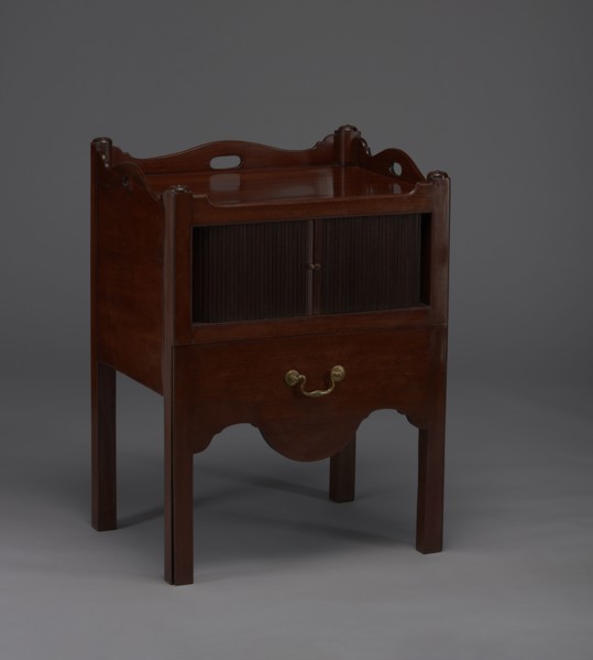 Bedside table with toilet, with a tambour door in the upper section and a pull-out section below