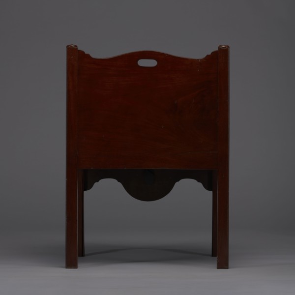 Bedside table with toilet, tambour door in the upper section and a pull-out section below with a