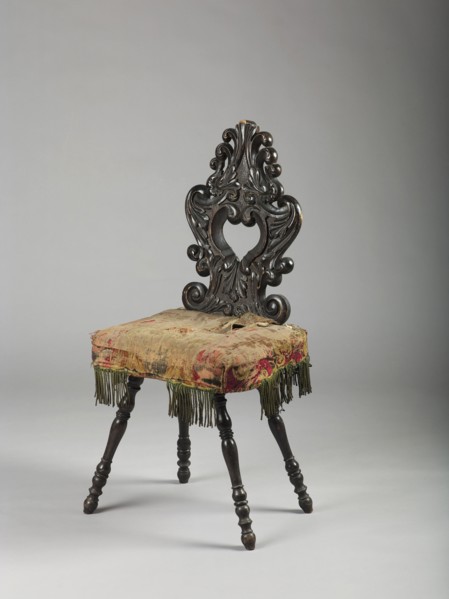 Stool with board seat, cushion attached, and openwork carved backrest; supported by four baluster