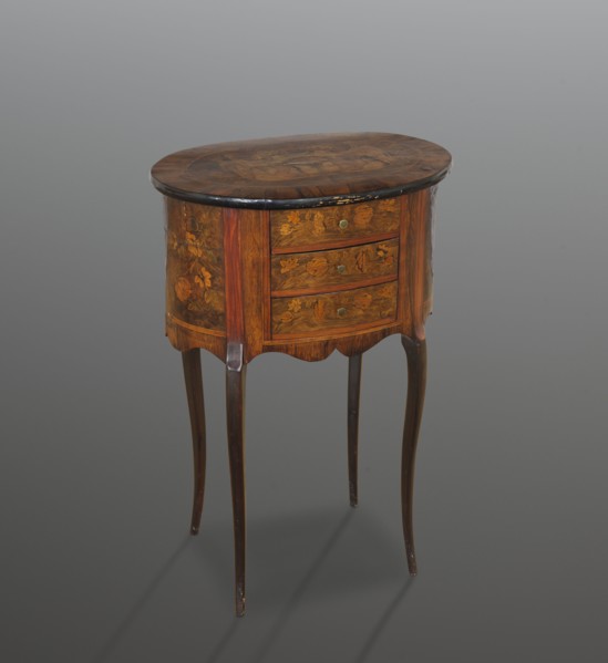 Chest of drawers table, classicism and rococo styles, floral decorations. Oval chest with a tall