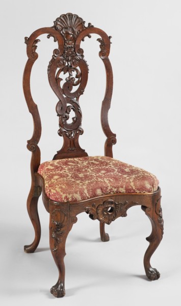 Chair, Carved chair with a padded seat inserted cushion and a high backrest filled by an openwork