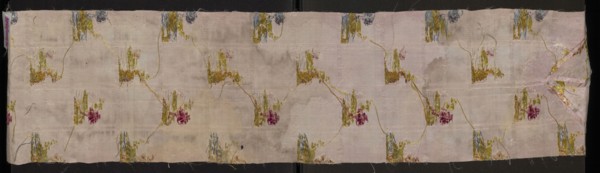 Fragment of pale pink silk fabric brocaded with colorful threads and silver thread. Brocade