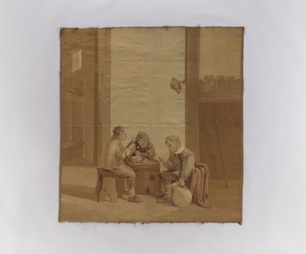 Figural tapestry. Genre scene in an inn: inside a farm building or stable, three men sit at a table