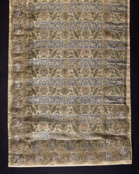 Fragment of a belt with a continuous pattern of alternating silhouetted tendrils with an iris motif