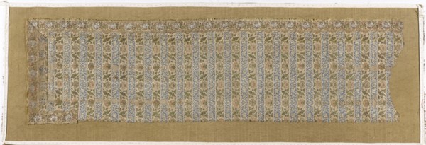 Fragment of a belt with a continuous pattern of alternating silhouetted tendrils with an iris motif