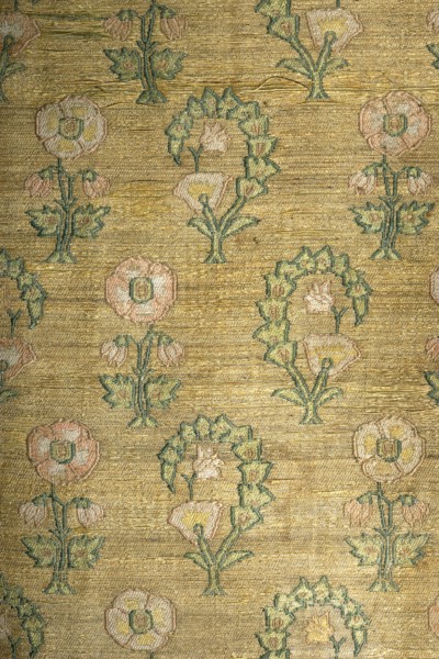 Tapestry, sewn from two fabrics. Rectangular central field of silk ikat fabric, interwoven with