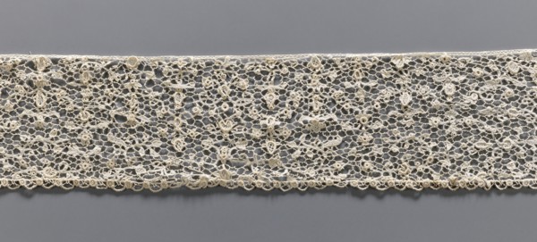 Lace fragment, lace with a fine floral pattern; de brides background with picots; lower edge with