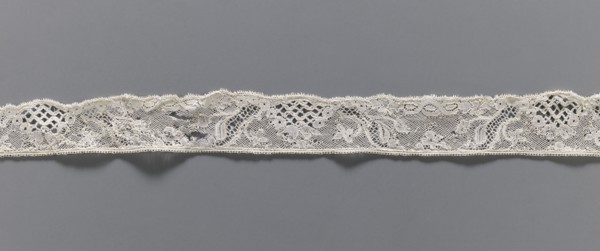 Lace fragment, floral ornaments, Malines lace, pattern with motifs of winding ribbons, flowers, and