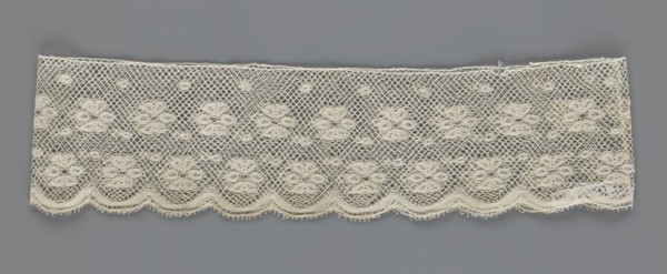 Fragment of lace, lace, a section of a belt sewn into a closed circle with one-sided arched