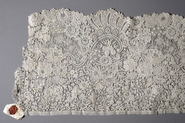 Fragment of Brussels lace; floral ornaments of densely placed roses, leaves, rocaille and