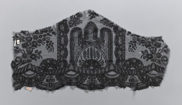 Lace fragment, plant ornaments. Preserved ruffle fragment features a symmetrical ornament of a
