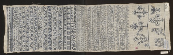 Embroidery sampler, Sampler with a cross-stitch pattern of trails, flower bushes, and letters. Blue