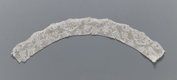 Lace fragment, Binche lace, slightly rounded in shape. The lower edge is slightly serrated, the