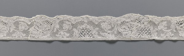 Lace fragment, lace, mesh background with rounded meshes. The lower edge is slightly serrated. The