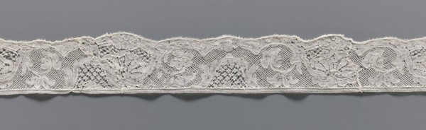 Lace fragment, lace, mesh background with rounded meshes. The lower edge is slightly serrated. The