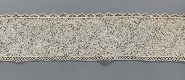 Fragment of bobbin lace with plant ornaments, 18th century, Flanders;, width 7 cm, length 74 cm., A