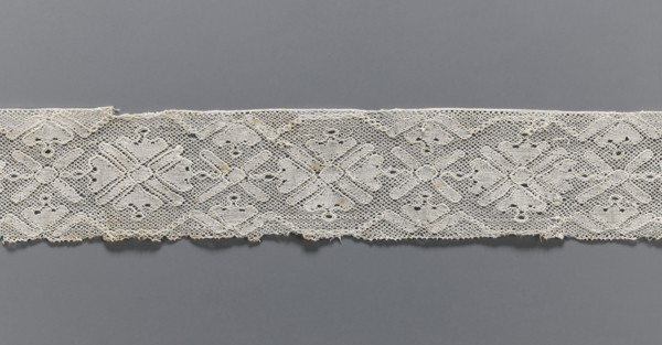 Lace fragment, bobbin lace with rosette ornaments framed by a tendril motif at top and bottom; mesh