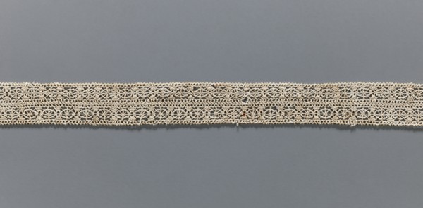 Fragment of needle lace, 16th–17th century, Flanders; width 2.8 cm, length 55 cm; provenance: