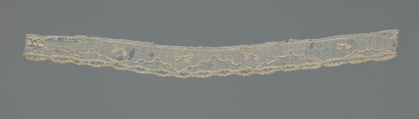 Lace fragment, needle-stitched lace, highly elongated openwork ovals. Above the edge ornament,