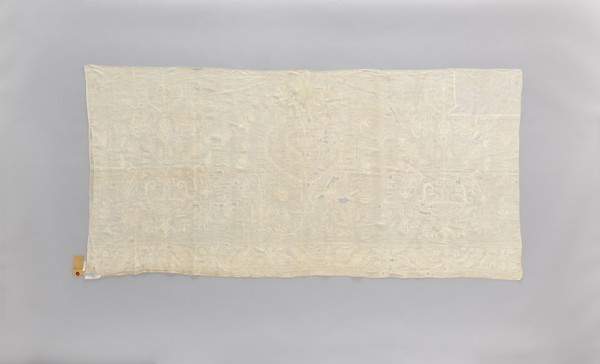 Church napkin made of white linen, covered with white, partially openwork embroidery. In the center