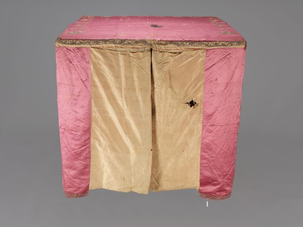 Church cope, liturgical vestment, raspberry satin embroidered with floral patterns. On the front,
