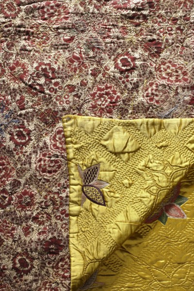 Quilt, Satin quilt, quilted and covered with multicolored embroidery in stylized flower patterns.
