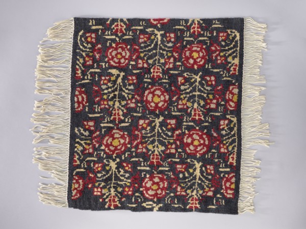 Tapestry covering; floral ornaments and stylized flower trees identical on the seat and backrest;