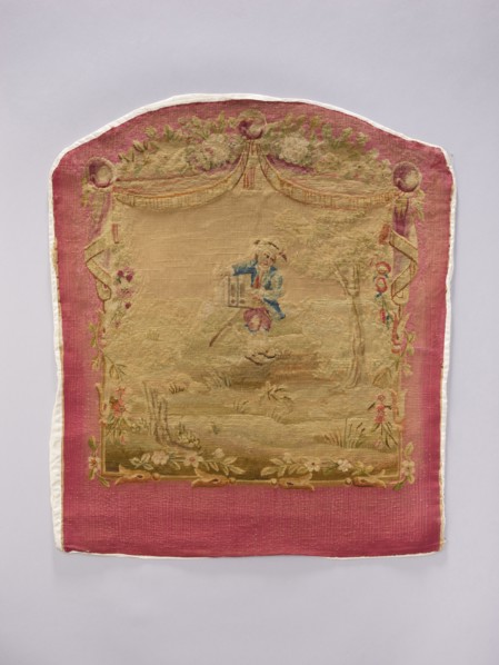 Tapestry covering depicting floral ornaments and boys in pastoral scenes, draperies suspended above