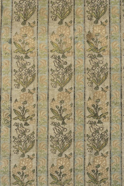 Fabric fragment. Gold-plated silk with a motif of irises and carnations in vertical stripes. Floral