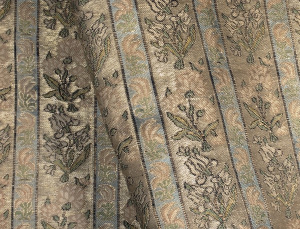 Fabric fragment. Gold-plated silk with a motif of irises and carnations in vertical stripes. Floral