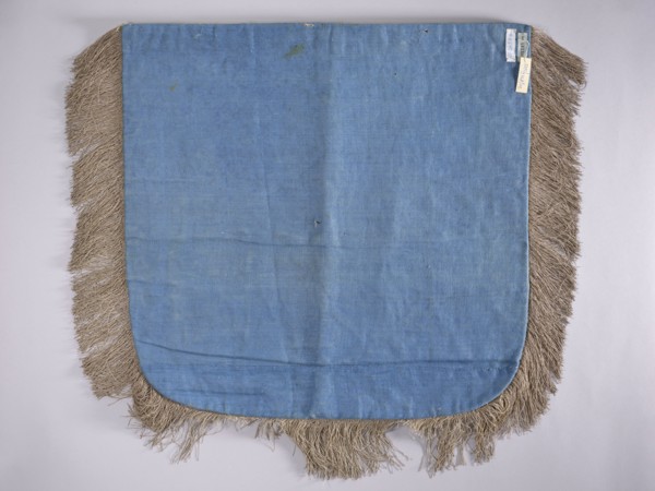 A hood from a church cope. The cope hood is made of pale green velvet. In the center, two