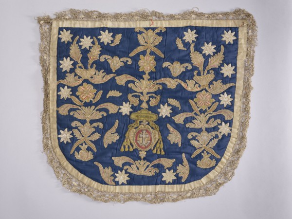 A hood from a church cope. The hood of the liturgical cope is made of navy blue silk with appliquéd
