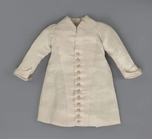Children's dress made of cream satin. Long, fitted at the top, slightly flared at the bottom.