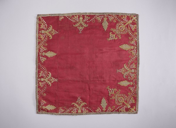Velum of dark red satin embroidered around the edges with gold and silver thread in motifs of