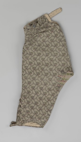 Trousers; short, knee-length trousers sewn into a wide belt, with a buttoned fly, made of silver