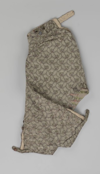 Trousers, short knee-length trousers sewn into a wide belt with a buttoned fly; made of silver lamé