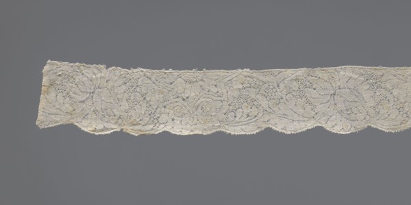 Lace fragment, early 18th century, Binche. Plant ornaments with rosette and rose motifs; twig motif