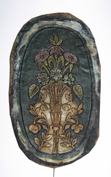 Fragment of a cordovan armrest, cordovan leather, flowers, flower bouquets, furniture upholstery.
