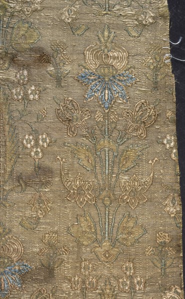 Fabric fragment, silk, fragments of patterned floral/plant motifs. Stylized plant motifs on a