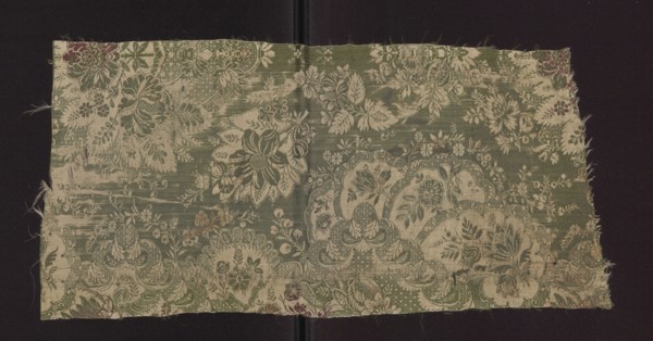 Fabric fragment, early 18th century, France. Silk fabric with preserved patterned and lace-like