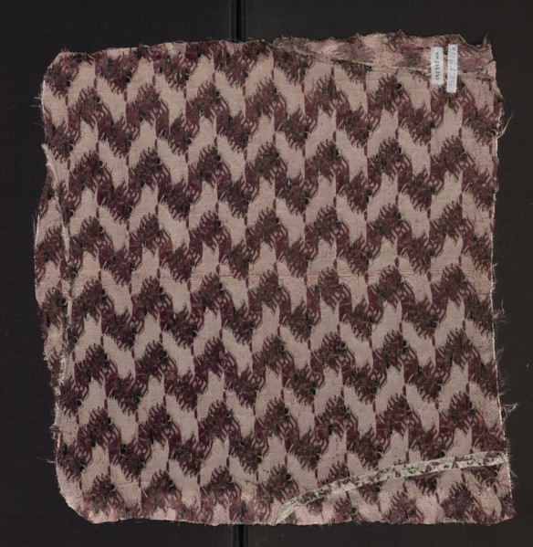 Fabric fragment of patterned silk with floral motifs on a white background motifs in pale pink,