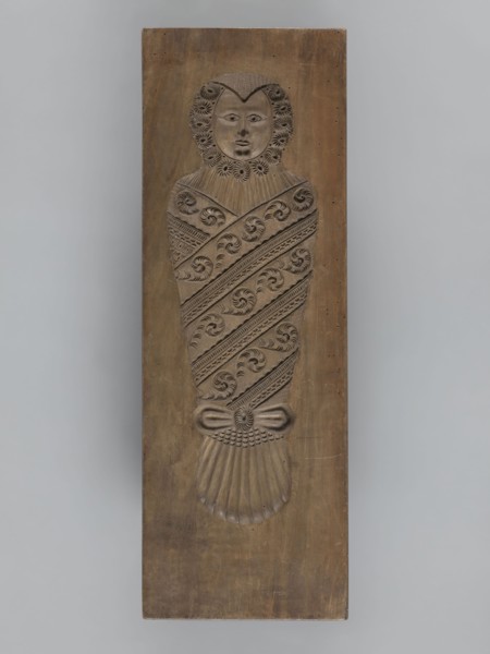Double-sided gingerbread mould. Side A: image of a bachelor; Side B: baby in swaddling clothes.,
