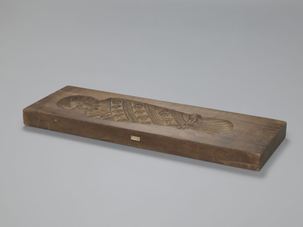 Double-sided gingerbread mould. Side A: image of a bachelor; Side B: baby in swaddling clothes.