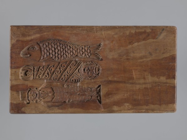 Double-sided gingerbread mould. Side A: bison; Side B: three figures — a bachelor in
