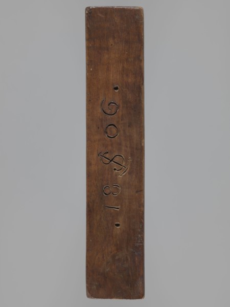 Double-sided gingerbread mould. Side A: bison. Side B: three figures — a bachelor in early