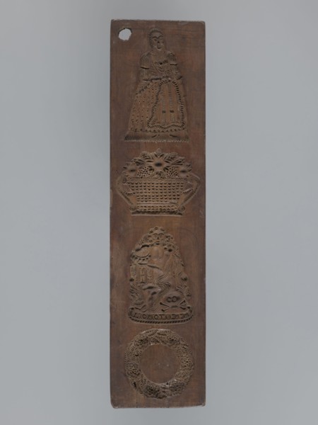 Double-sided gingerbread mould. Obverse: four images—top: female figure in a long patterned dress