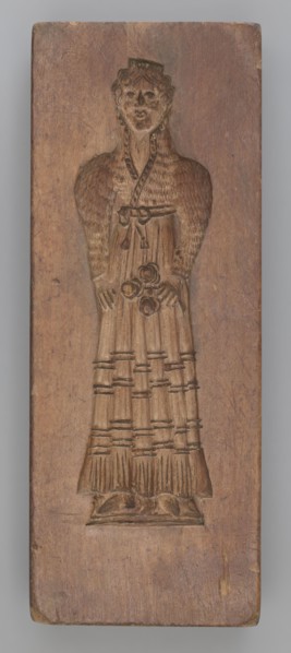 Double-sided gingerbread mould. Side A: female figure in a decorative, pleated early 19th-century