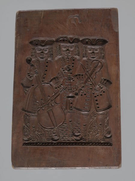 Double-sided gingerbread mould. Obverse: group of musicians; Reverse: three fish. Double-sided,