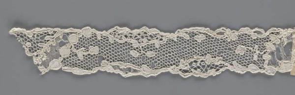 Lace fragment, mid-18th century, France. Lace with an ornament carried on two edges and a free